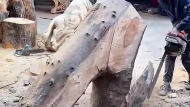 Man carves amazing sculpture from dead tree