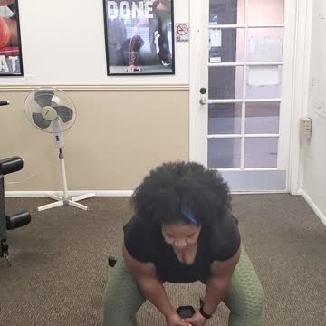Celly doing kettlebell swings using a dumbbell