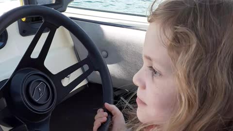 8 year old daughter, Abbi, driving our boat