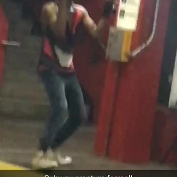 Guy black red shirt hat dancing subway hands