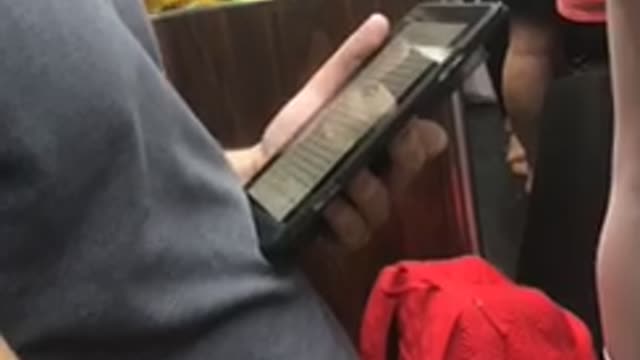 Guy yellow shirt gloves hitting green ball subway