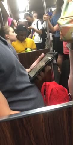 Guy yellow shirt gloves hitting green ball subway