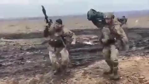 Ukrainian soldiers who shot a Russian tank celebrate.