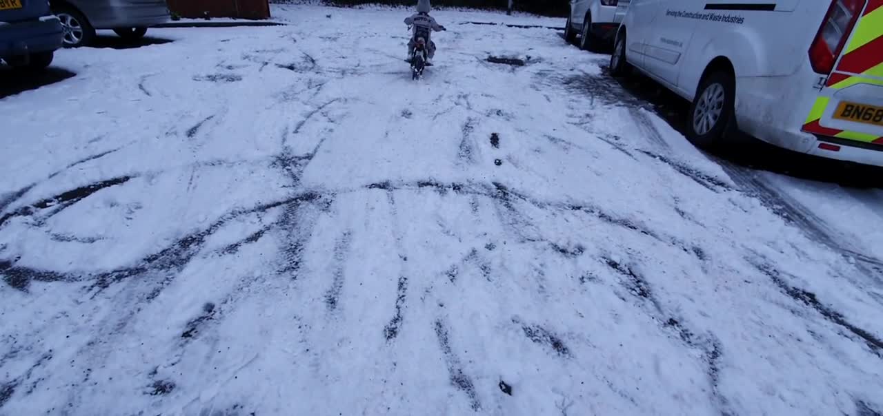 Tough Little Boy Slips While Riding His Electric Dirtbike On Snow