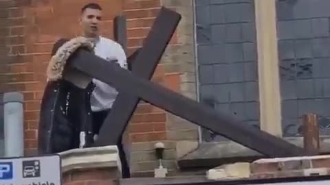 Dirty Migrant takes down a cross on the Church