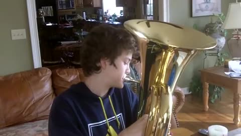 Caleb plays _O Canada_ on tuba