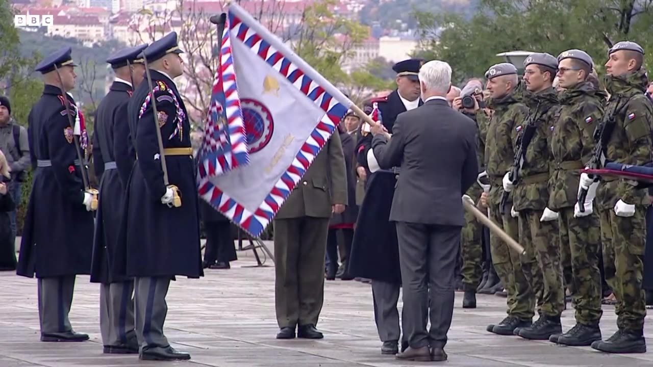 Moment Czech president knocks soldier's hat off by striking him with flagpole