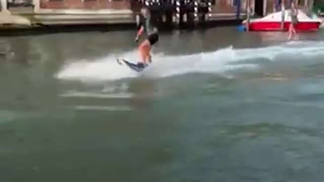 Surfers spark outrage for surfing down Venice’s Grand Canal