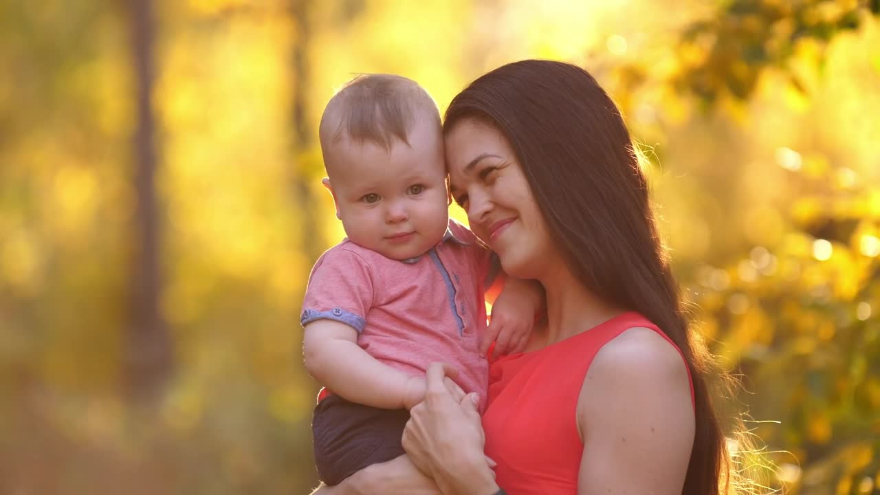 Young happy mother with her baby in nature