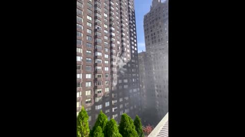 Footage shows person dangling from window in NYC fire