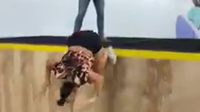 Girl Falls to the Ground Trying a Pull Over on a Trampwall
