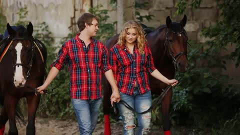 loving couple on a walk in the park with horses