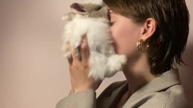 .Woman Holding a Rabbit Close to Her Face