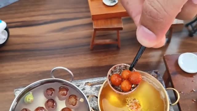 Cute kitchen making Rasgulla