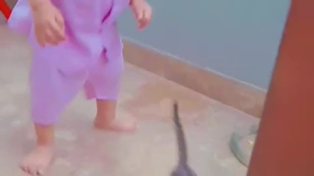 Cute baby playing with his cat