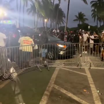 Miami, Florida: Out of control crowd of Spring Breakers destroy a vehicle by jumping on car hood...