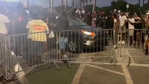 Miami, Florida: Out of control crowd of Spring Breakers destroy a vehicle by jumping on car hood...