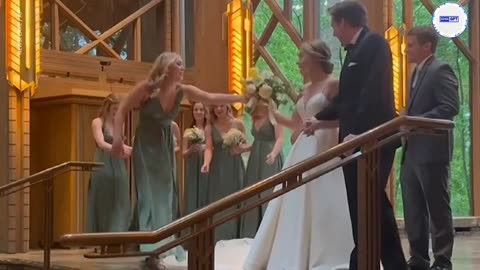 Look out! Maid of honor hits the deck after slipping on bride's dress