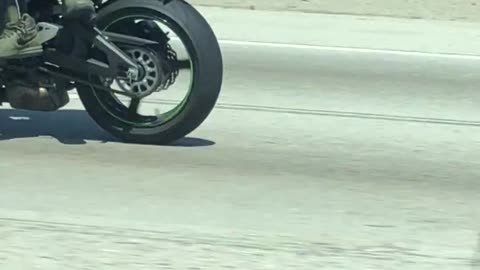 Motorcyclist Rides Sidesaddle on the Freeway