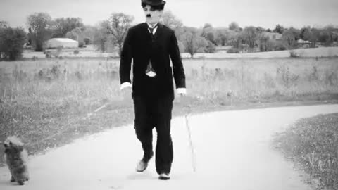 Charlie Chaplin walking his dog.