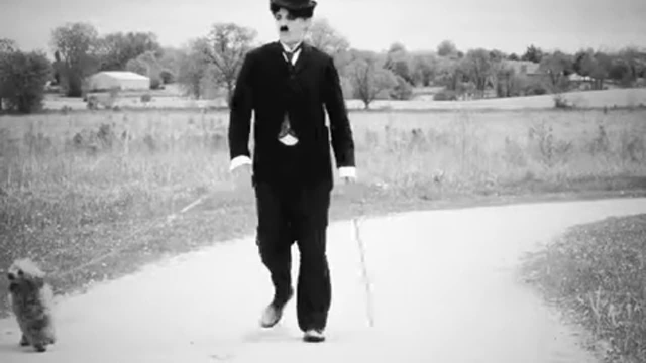 Charlie Chaplin walking his dog.