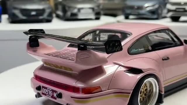 Sexy pink Porsche with champagne gold wheels. It's so cool!