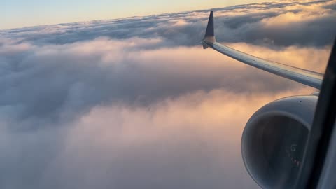 Cloud surfing at sunrise after taking off from Cleveland (737-MAX9)