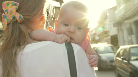 Mother and baby walking in the sun