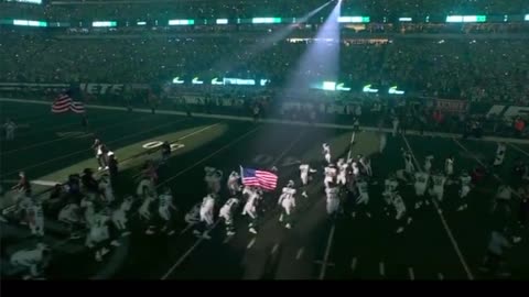 Aaron Rodgers enters the game as a Jet carrying the Flag on 9/11 anniversary