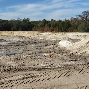 Digging up of edge of North Black Creek Middleburg Florida