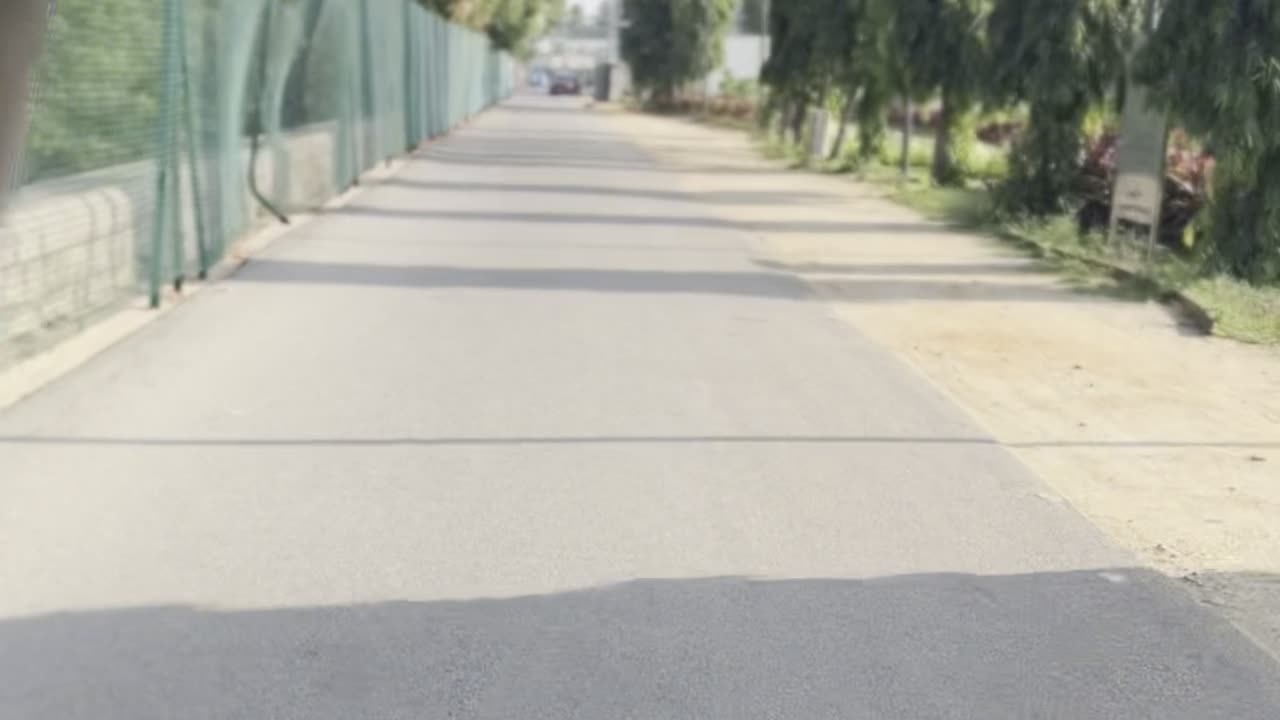 Riding motorcycle on a straight road with a nice view and trees.