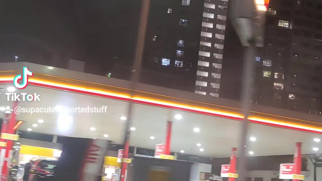 Driving past a petrol station in Singapore on a rainy night