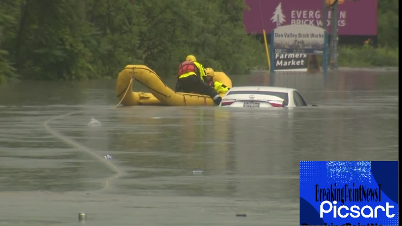 Toronto floods_ Emergency crews rescue driver stranded on top of car