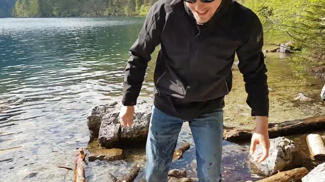 Guy Splashes Into Water While Trying to Jump Over Rocks in the River