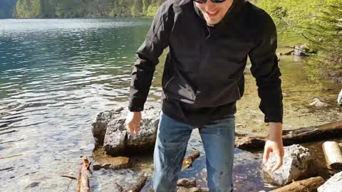 Guy Splashes Into Water While Trying to Jump Over Rocks in the River