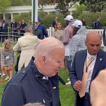 Joe Biden has a costumed Easter Bunny handler moving him along
