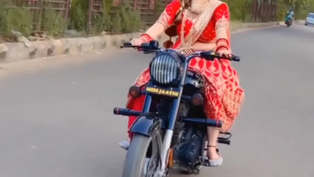 Indian beauty riding royal Enfield bike in traditional look