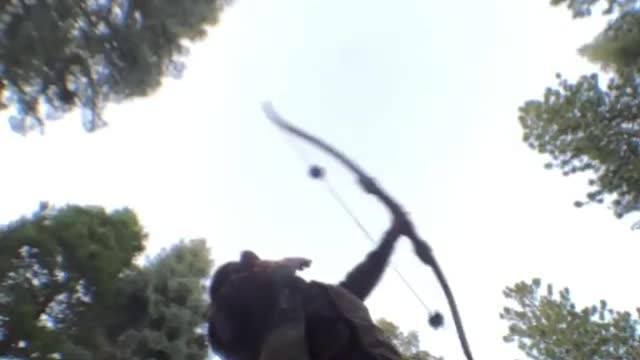 Guy Shoots Arrow in the Air and Catches it With his Hand as it Falls