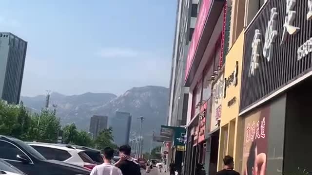 Vehicles parked on the side of the road and majestic mountains