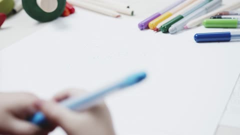 A Young Girl Using Coloring Pen To Draw On A White Paper