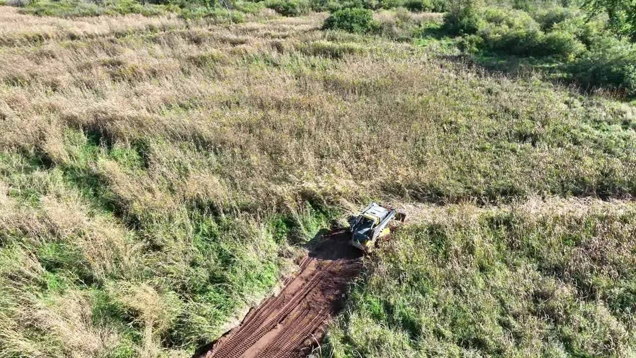 Two Skidsteers putting in New Culvert & Road on the farm