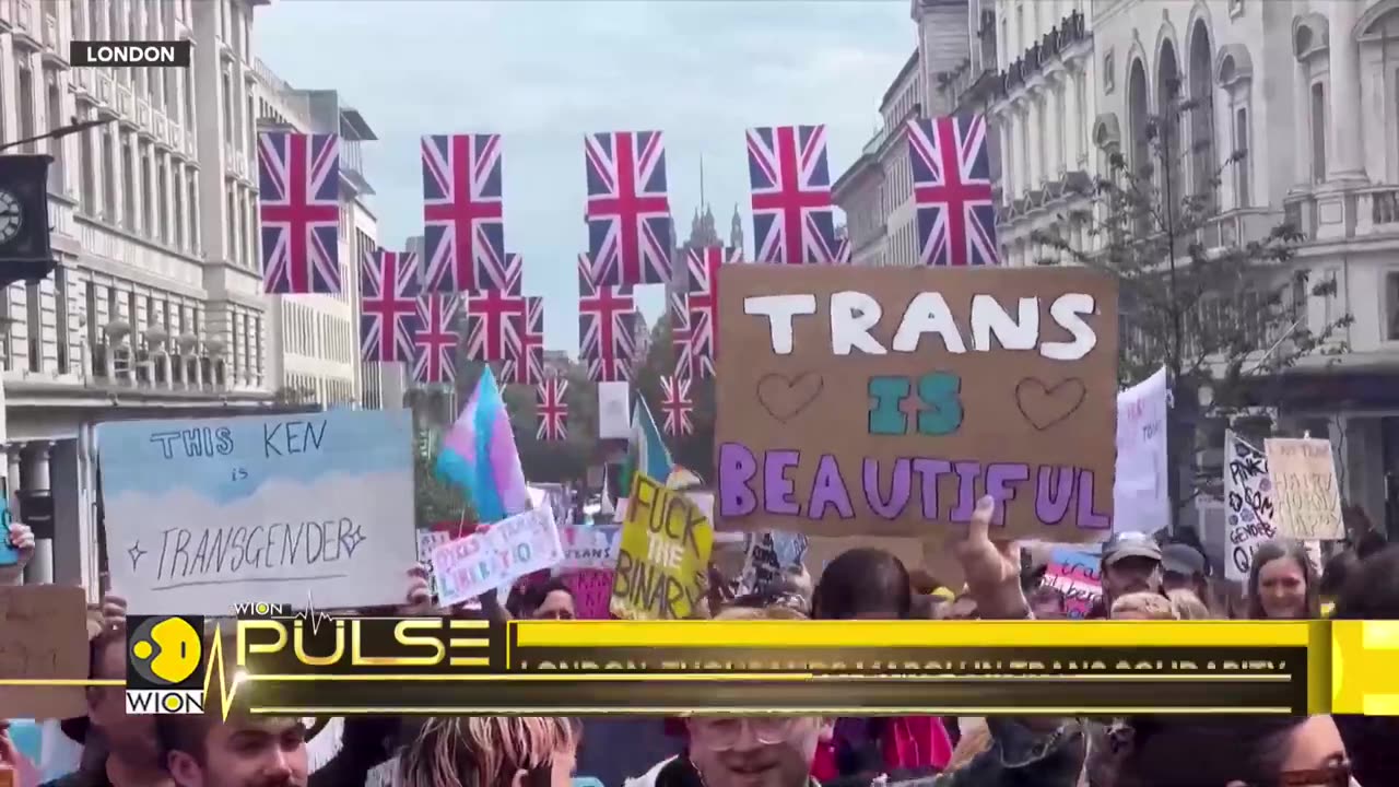 London: People draped in trans flags, with pride umbrellas against rain | UK | Latest News |