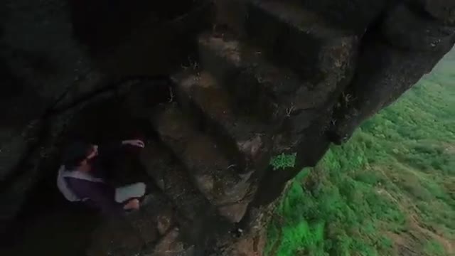 Traveler Treks Narrow Stairs on Side of Hill