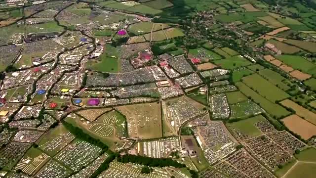 Aerials of music fans arriving at Glastonbury Festival