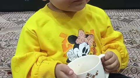 Baby Girl Taking Tea At Home