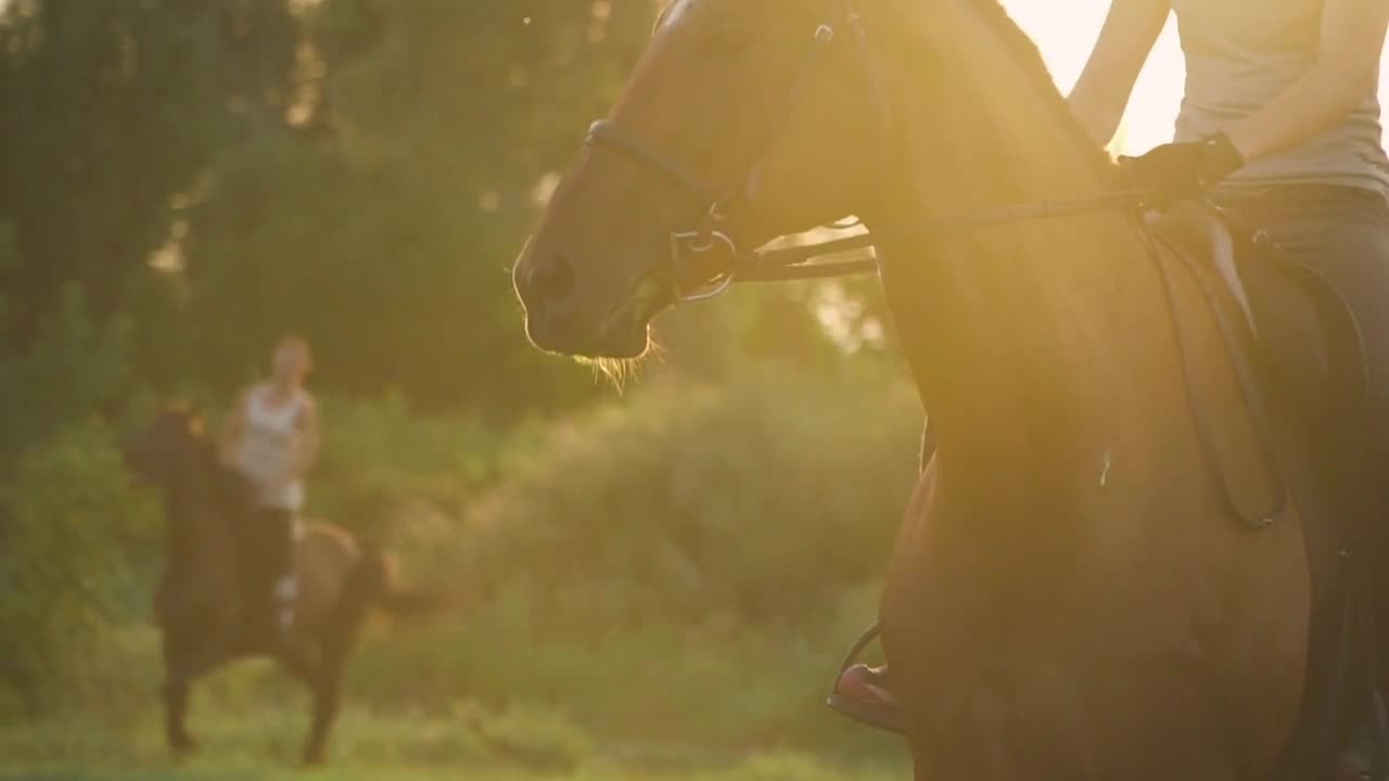 Two girls ride horses