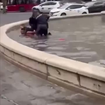 something naked jumps in a fountain