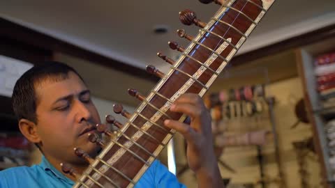 Man Playing a Sitar