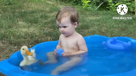 Funny baby reaction to duckling in the pool