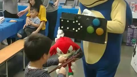 Blue hedgehog sonic takes aim with the extending boxing glove at birthday party in wonder wild